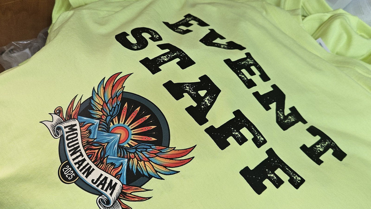 Neon safety green event staff shirts with a full-color crest, printed by KSTMYZE
