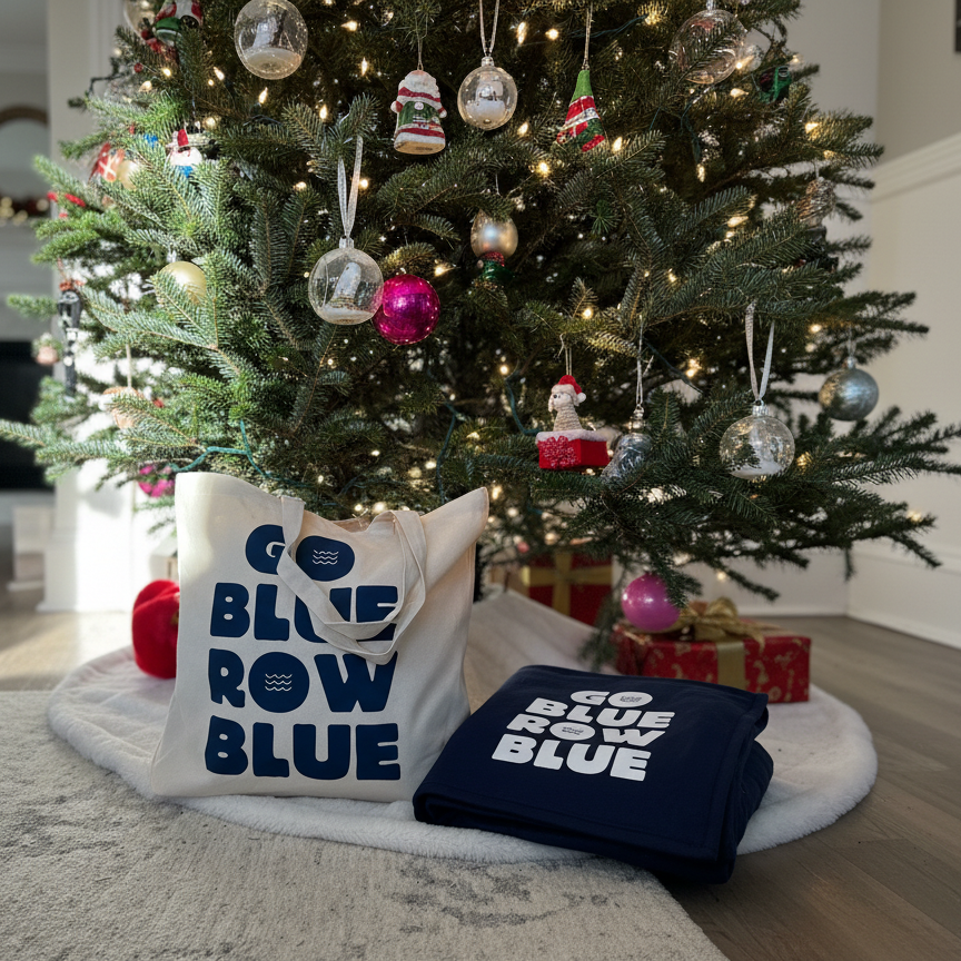 Decorative pillows with 'Go Blue Row Blue' text in front of a Christmas tree.