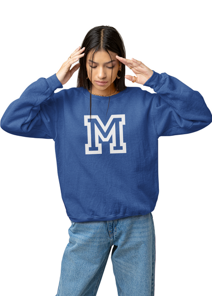 Person wearing a blue sweatshirt with a white 'M' logo on a neutral background